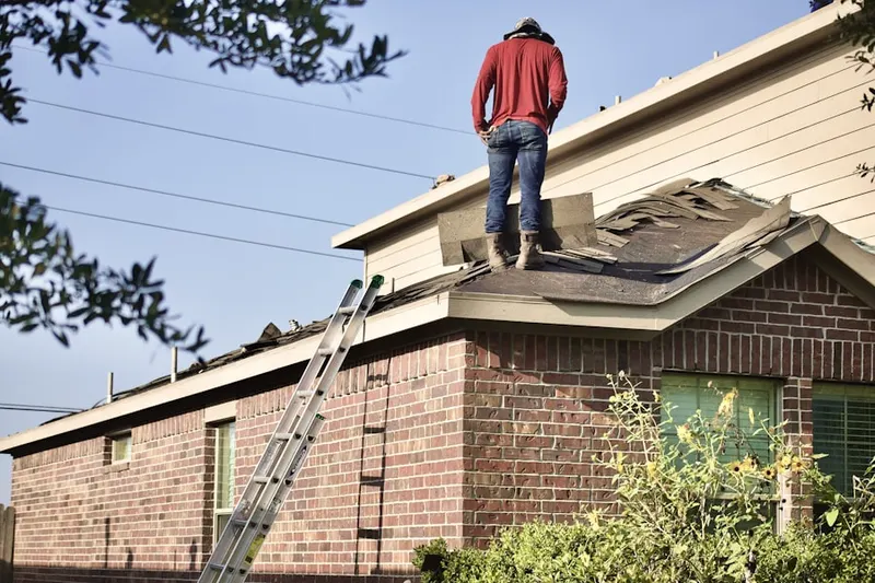 Professional roofer working on a residential roof in O'Bryonville